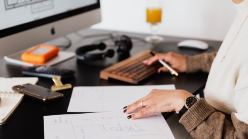 Office worker typing on a computer with focus on wrist positioning to prevent injury