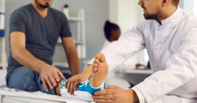 orthopedic doctor looking at ankle injury