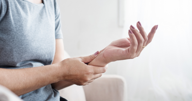 Woman experiencing hand numbness